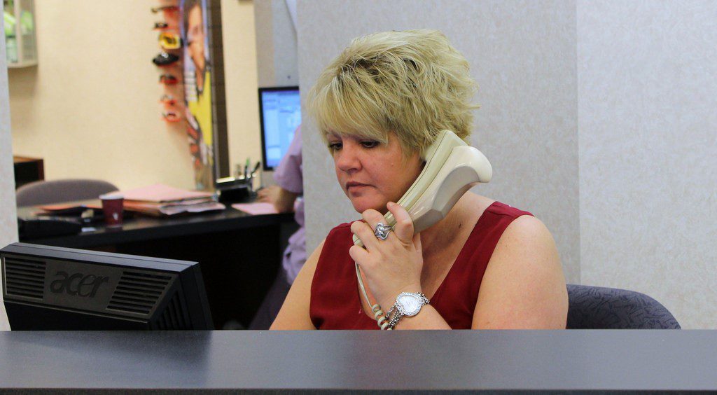 receptionist at dental office answers the phone