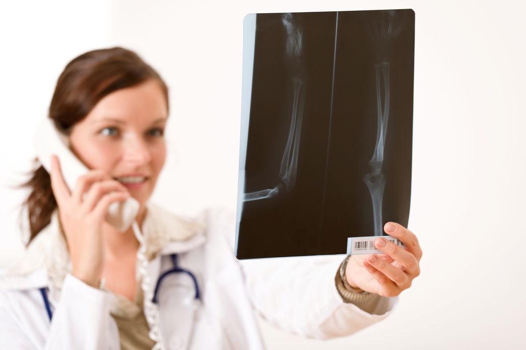 female doctor on phone with xray